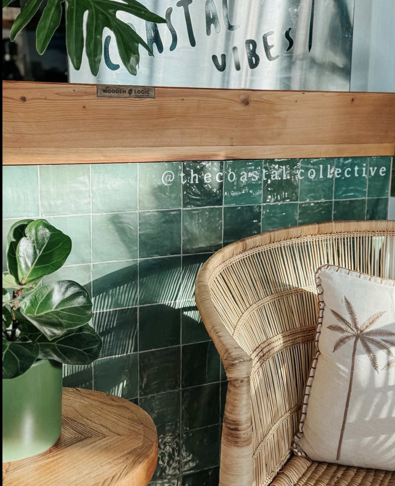 Sea-green zellige tile wall with rattan chair